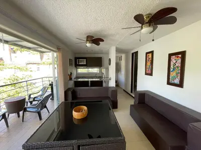 a living room with a couch and a table at Apartasol privado Santa Fe de Antioquia in Santa Fe de Antioquia