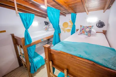 a bedroom with a bunk bed and blue curtains at Spring Hostel in Medellín