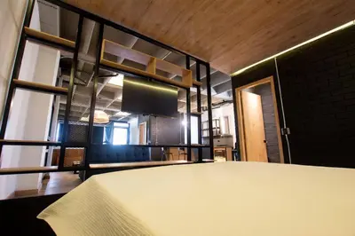 a room with a kitchen with a table in it at Deluxe Man cave with jacuzzy in Envigado