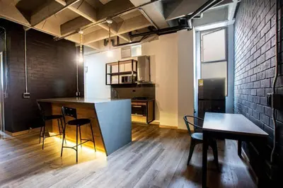 a kitchen with a counter and a table and chairs at Deluxe Man cave with jacuzzy in Envigado