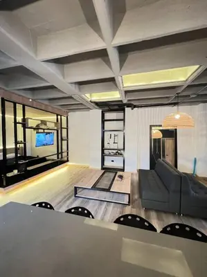 a living room with a couch and a television at Deluxe Man cave with jacuzzy in Envigado