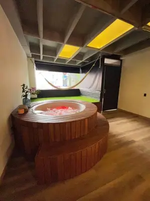 a room with a large tub in the middle of a room at Deluxe Man cave with jacuzzy in Envigado