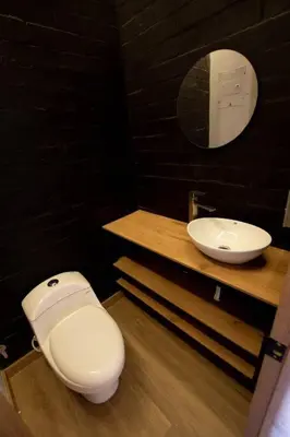 a bathroom with a white toilet and a sink at Deluxe Man cave with jacuzzy in Envigado