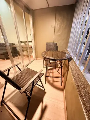 a table and chairs in a room with a balcony at Arrendamiento nuevo apartamento con balcón By Roots Rentals NID202 in Medellín