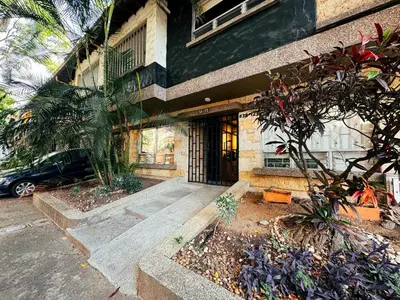 a building with a front door of a building at Arrendamiento nuevo apartamento con balcón By Roots Rentals NID202 in Medellín