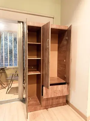 a wooden cabinet in the corner of a room at Arrendamiento nuevo apartamento con balcón By Roots Rentals NID202 in Medellín