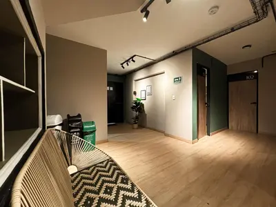 an empty room with a hallway with a wooden floor at Nuevo estudio cerca de Plaza Mayor NID101 By Roots Rentals in Medellín