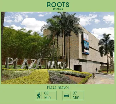 a sign in front of a building with a palm tree at Nuevo estudio cerca de Plaza Mayor NID101 By Roots Rentals in Medellín