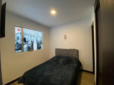 a bedroom with a bed and a picture on the wall at Torres de San Vicente 2 hab in Manizales