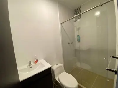 a bathroom with a toilet and a sink and a shower at Torres de San Vicente 2 hab in Manizales