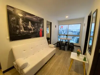 a living room with a white couch and a table at Torres de San Vicente 2 hab in Manizales