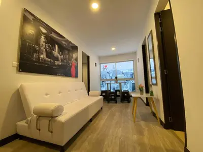 a living room with a white couch and a table at Torres de San Vicente 2 hab in Manizales
