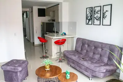 a living room with a purple couch and two tables at Apartamento en zona exclusiva de Bello, Cabañas in Bello