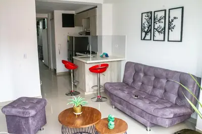 a living room with a purple couch and two tables at Apartamento en zona exclusiva de Bello, Cabañas in Bello