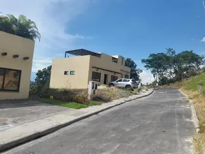 a house with a car parked on the side of a road at Cabaña en Sopetran in Sopetran