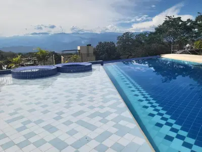 a swimming pool with a view of mountains at Cabaña en Sopetran in Sopetran
