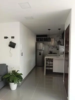 a kitchen with a refrigerator and a table in it at nuevo amanecer in Bello