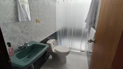 a bathroom with a green sink and a toilet at CASA DE LOLA in Medellín