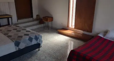 a bedroom with a bed and a window in it at CASA DE LOLA in Medellín