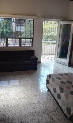 a living room with a bed and a couch at CASA DE LOLA in Medellín
