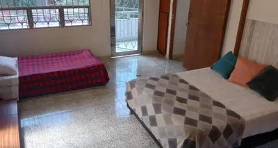 a living room with a bed and a couch at CASA DE LOLA in Medellín