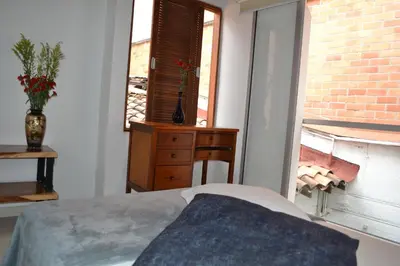 a bedroom with a bed and a window at CASA DE LOLA in Medellín
