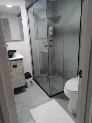 a bathroom with a glass shower with a toilet at Hotel la Carpita in El Poblado