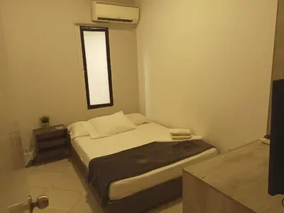 a small bedroom with a bed and a window at Hotel la Carpita in El Poblado