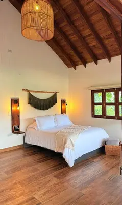 a bedroom with a large bed in a room at Cabañas Sentido Ancestral in Jardin