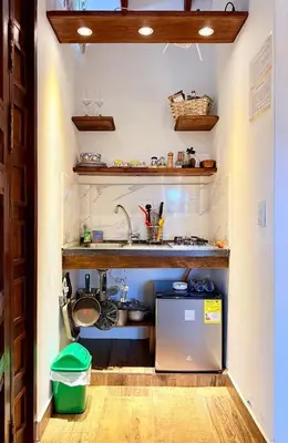 a small kitchen with a sink and a refrigerator at Cabañas Sentido Ancestral in Jardin