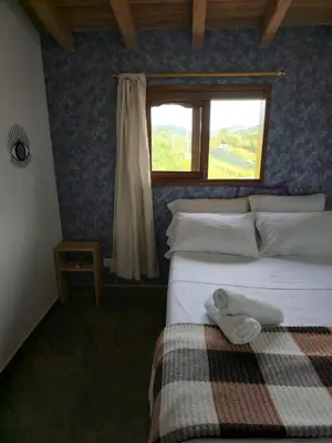 a bedroom with a bed and a window at Finca Completa Carmen Viboral Naturaleza y Privacidad in Carmen de Viboral