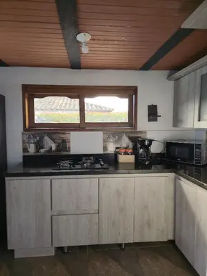 a kitchen with a counter top and a window at Finca Completa Carmen Viboral Naturaleza y Privacidad in Carmen de Viboral