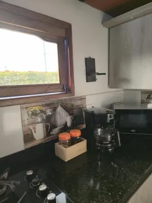 a kitchen with a counter top with a coffee maker at Finca Completa Carmen Viboral Naturaleza y Privacidad in Carmen de Viboral