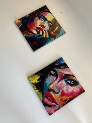 two paintings of a woman on a wall at Apartamento de lujo Manizales in Manizales