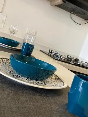a blue bowl on a plate on a table at Apartamento de lujo Manizales in Manizales