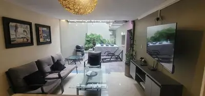 a living room with a couch and a table at Libertador in Medellín