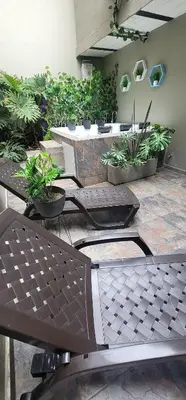 a patio with a bunch of potted plants and benches at Libertador in Medellín