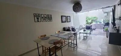 a living room with a table and chairs at Libertador in Medellín