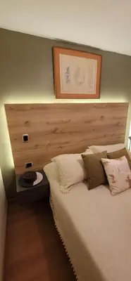 a bedroom with a bed with a wooden head board at Libertador in Medellín