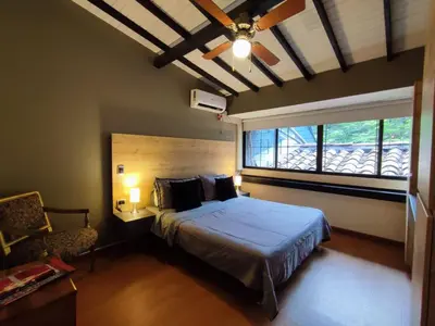 a bedroom with a large bed and a window at Libertador in Medellín