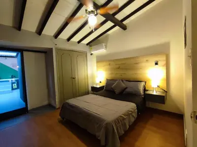a bedroom with a bed with two lamps and a ceiling at Libertador in Medellín