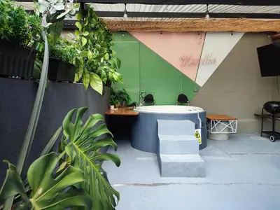 a bathroom with a bath tub and some plants at Libertador in Medellín