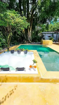 a table with glasses and plants on it in a pool at Luxury Home In Aguacatala in Medellín