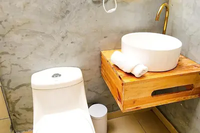 a bathroom with a white sink and a toilet at Luxury Home In Aguacatala in Medellín