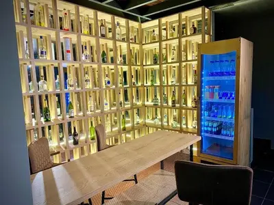 a room with a table and a wall of wine bottles at Luxury Home In Aguacatala in Medellín