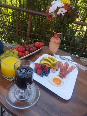 a breakfast plate of eggs and fruit on a table at Luxury Home In Aguacatala in Medellín