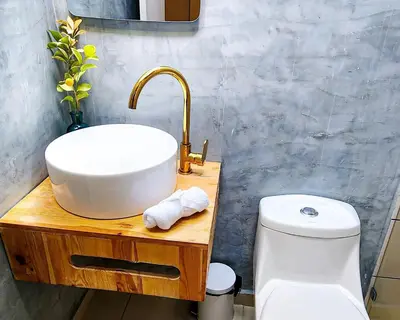 a bathroom with a sink and a toilet at Luxury Home In Aguacatala in Medellín