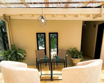 a dining room with a table and two chairs at Luxury Home In Aguacatala in Medellín