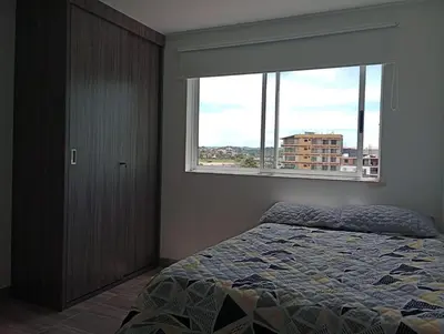 a bedroom with a bed and a large window at Lindo apartamento en Guatapé in Guatapé