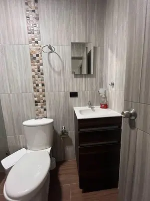 a bathroom with a white toilet and a sink at Lindo apartamento en Guatapé in Guatapé